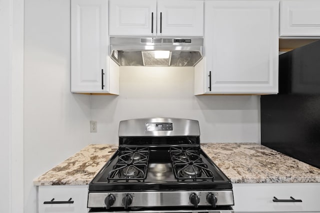 10001 Woodglen Dr, Austin, TX 78753 - kitchen with stainless steel range with gas stovetop, under cabinet range hood, freestanding refrigerator, white cabinets, and light stone counters