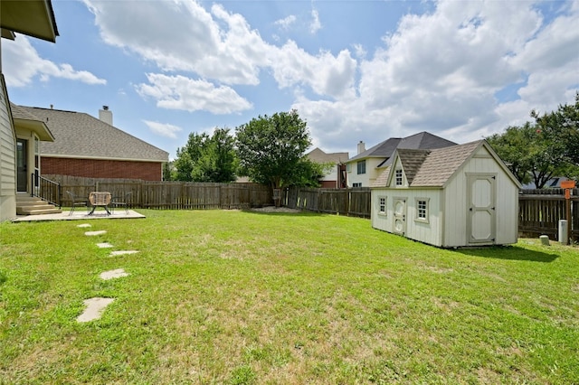 view of yard featuring entry steps, a shed, an outdoor structure, and a fenced backyard