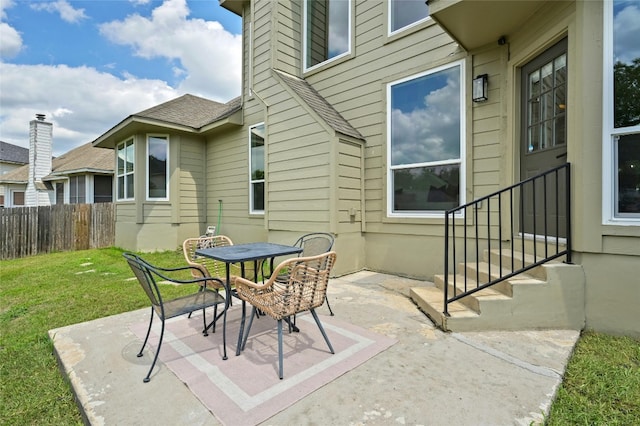 view of patio featuring outdoor dining space and fence