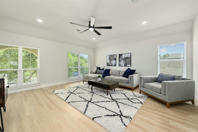 living area featuring light wood-style floors, recessed lighting, and a healthy amount of sunlight