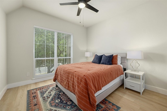 bedroom featuring ceiling fan, baseboards, and wood finished floors