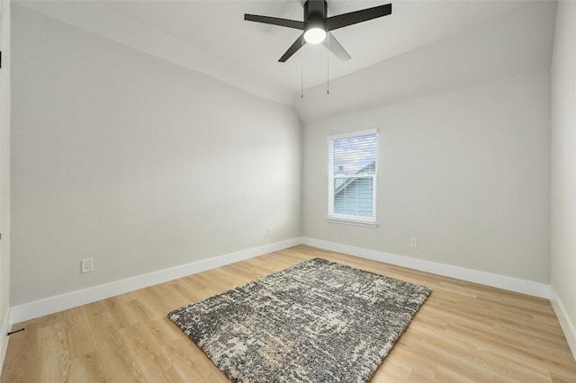 unfurnished room featuring lofted ceiling, a ceiling fan, light wood-style flooring, and baseboards