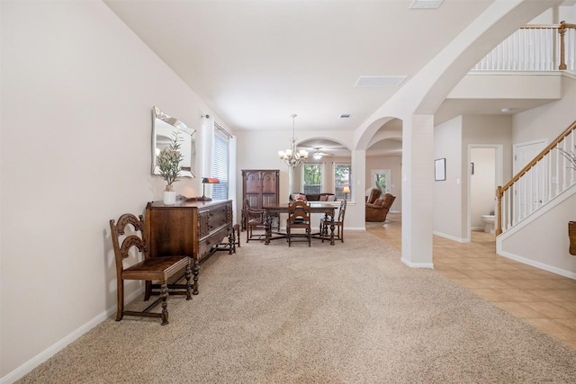 dining room featuring carpet floors, stairs, baseboards, and an inviting chandelier