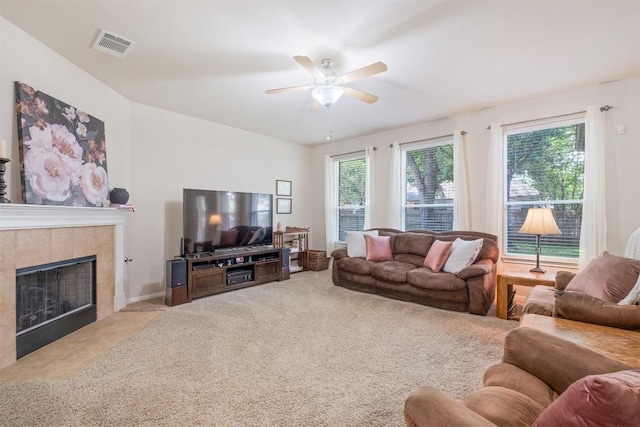 carpeted living room featuring visible vents, a fireplace, and ceiling fan