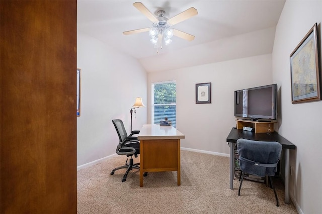 office area featuring light carpet, ceiling fan, baseboards, and vaulted ceiling