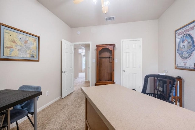 office space with light carpet, ceiling fan, visible vents, and baseboards