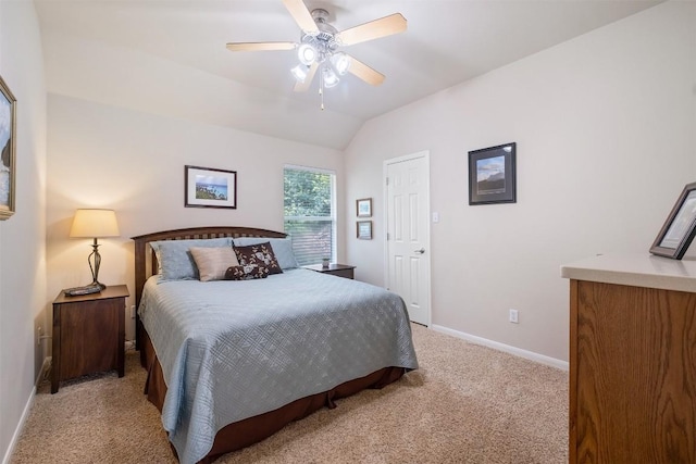 bedroom with ceiling fan, baseboards, vaulted ceiling, and light colored carpet