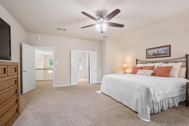 bedroom featuring baseboards, visible vents, a ceiling fan, light colored carpet, and lofted ceiling