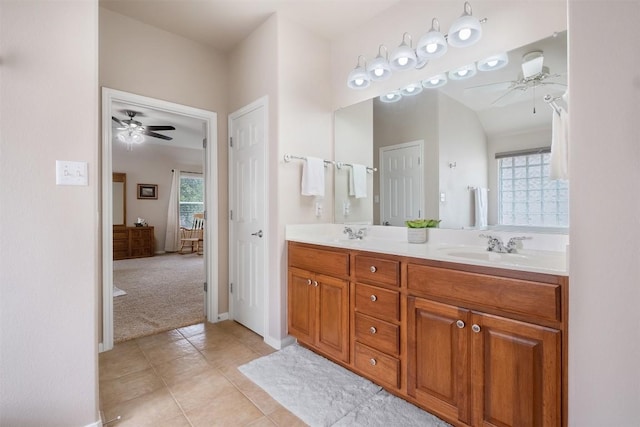 full bath with double vanity, ensuite bathroom, a ceiling fan, a sink, and tile patterned floors