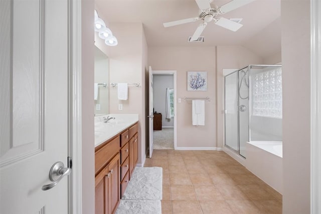 bathroom featuring double vanity, a stall shower, ceiling fan, a sink, and tile patterned flooring