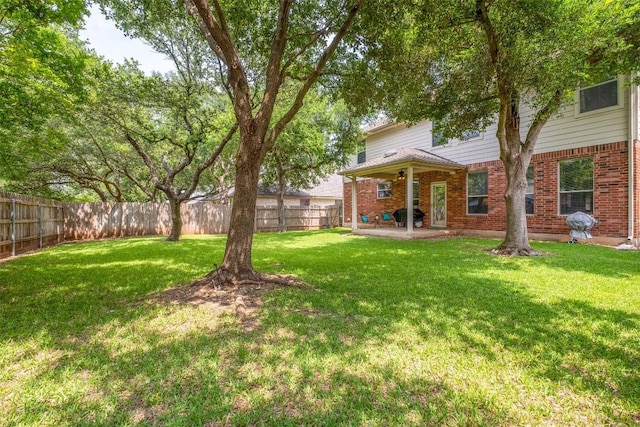 view of yard with a patio area and a fenced backyard