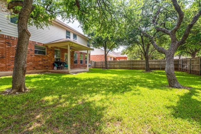 view of yard with a patio area and a fenced backyard