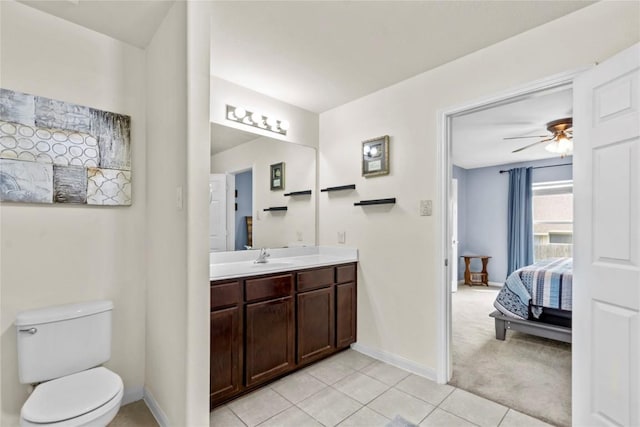 bathroom featuring baseboards, ensuite bath, ceiling fan, tile patterned floors, and vanity