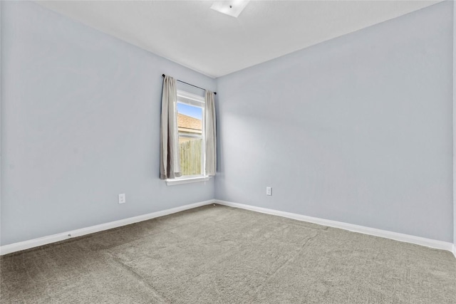 empty room with carpet and baseboards