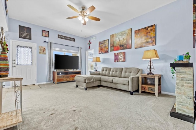 living room with carpet floors, a ceiling fan, and baseboards