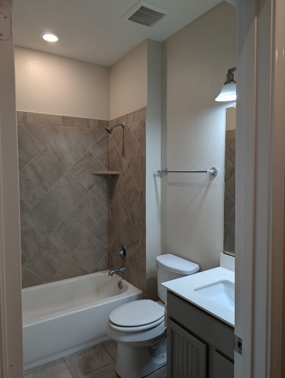 bathroom featuring shower / bathtub combination, visible vents, toilet, vanity, and tile patterned floors