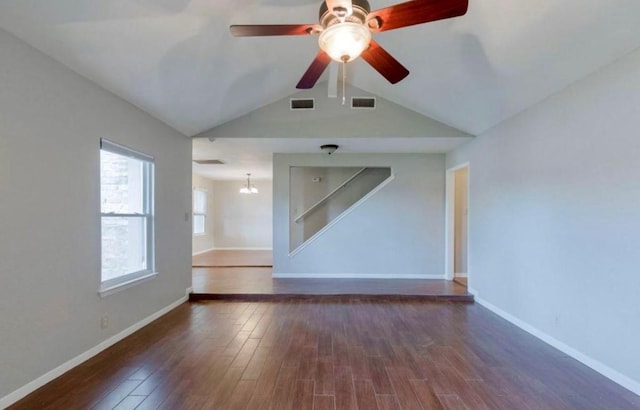 spare room featuring baseboards, visible vents, and wood finished floors