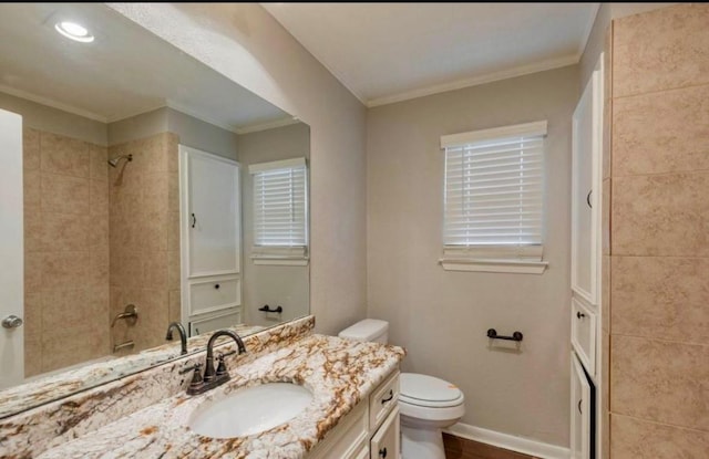 full bathroom featuring ornamental molding, vanity, toilet, and baseboards