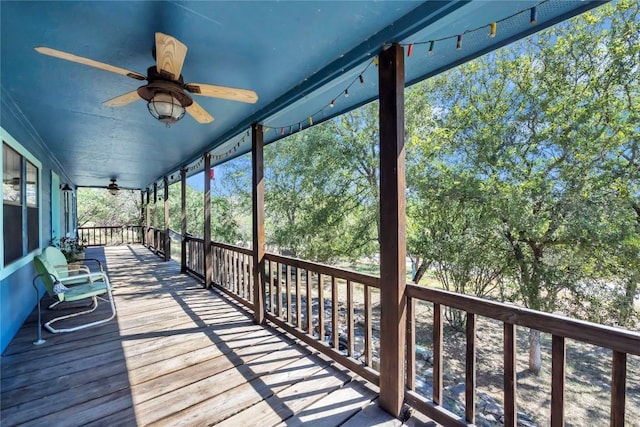 unfurnished sunroom with ceiling fan