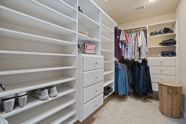 spacious closet with carpet flooring and visible vents