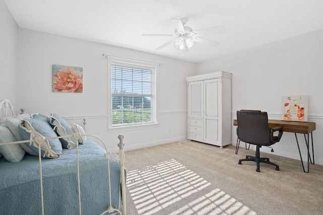 carpeted bedroom featuring a ceiling fan and baseboards