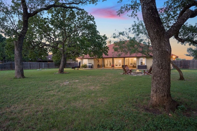 view of yard with an outdoor fire pit and fence