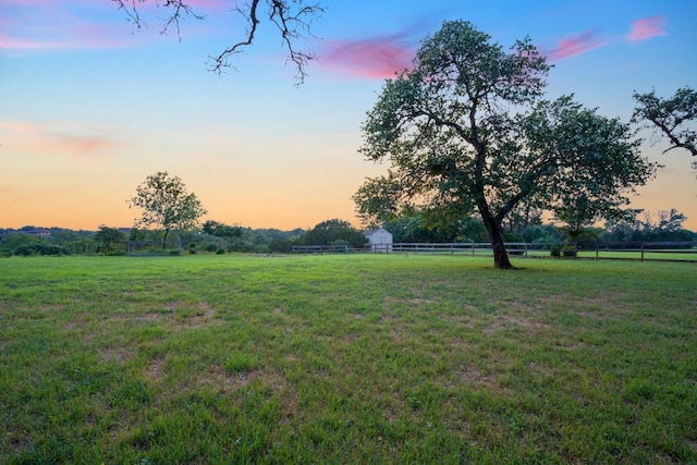 view of yard featuring fence and a rural view