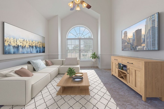 living room with ceiling fan, light colored carpet, baseboards, vaulted ceiling, and a view of city