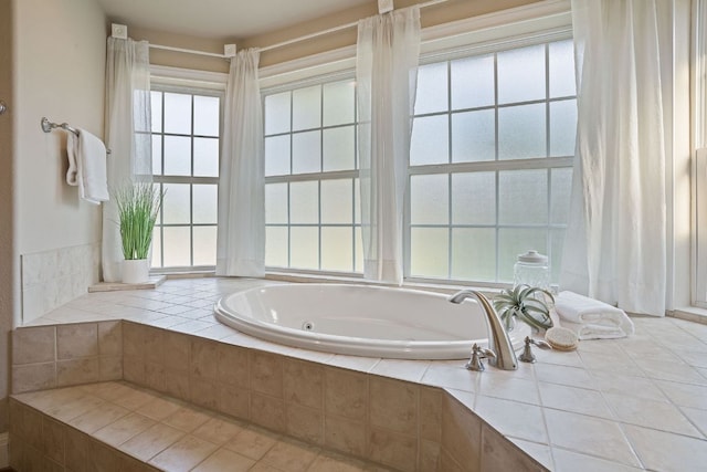 bathroom with a jetted tub and a wealth of natural light