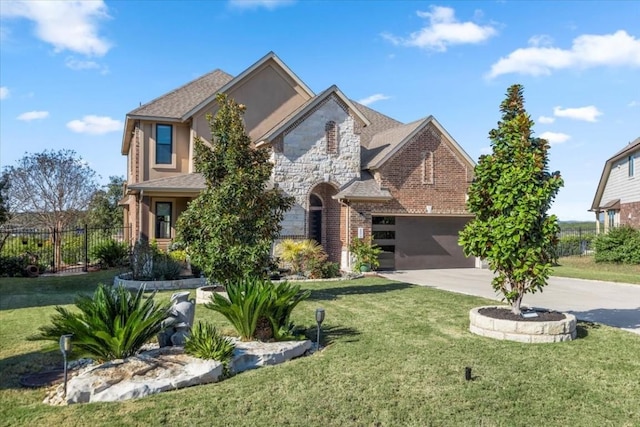 view of front of property with brick siding, fence, driveway, stone siding, and a front yard