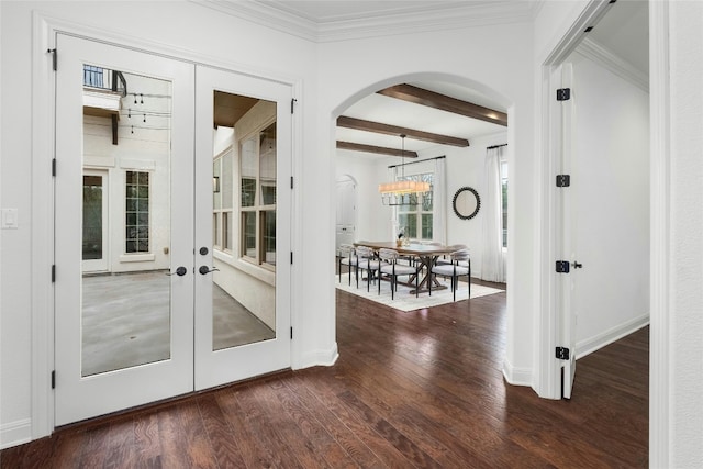 doorway to outside featuring arched walkways, ornamental molding, french doors, beam ceiling, and dark wood finished floors