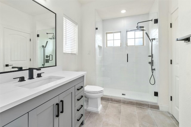 full bath featuring toilet, a shower stall, and vanity