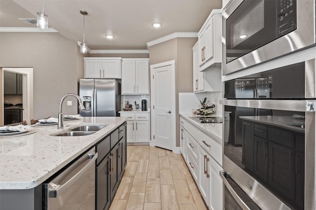 kitchen featuring white cabinetry, appliances with stainless steel finishes, and a sink