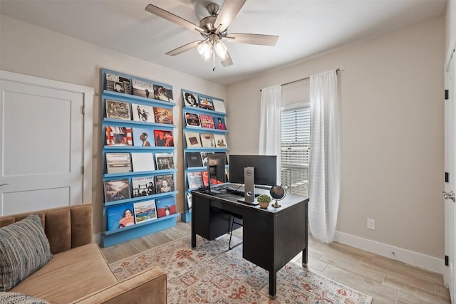 office space featuring wood finish floors, ceiling fan, and baseboards