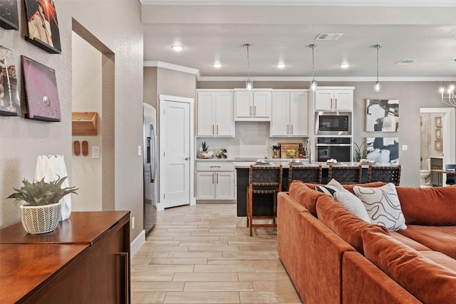 living area featuring wood tiled floor, visible vents, crown molding, and recessed lighting