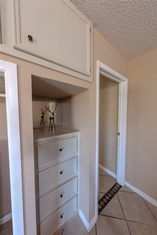 room details with a textured ceiling and baseboards