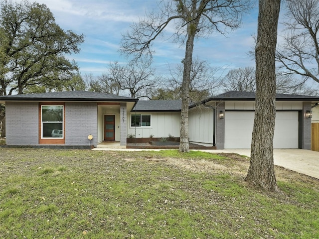 view of front of house with brick siding, board and batten siding, a front yard, a garage, and driveway