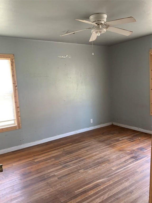 unfurnished room featuring ceiling fan, baseboards, and wood finished floors