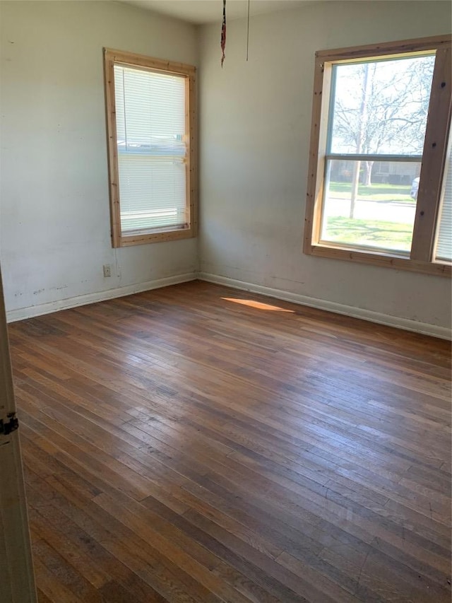 unfurnished room featuring dark wood finished floors and baseboards