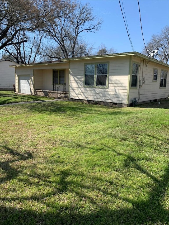 view of front of property with an attached garage, crawl space, and a front yard