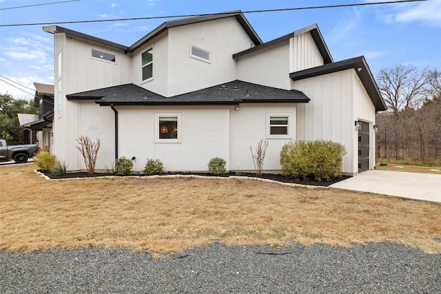 view of property exterior featuring board and batten siding, roof with shingles, driveway, and an attached garage