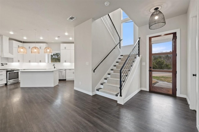 18200 Fair Ln, Jonestown, TX 78645 - foyer with dark wood finished floors, stairway, baseboards, and recessed lighting