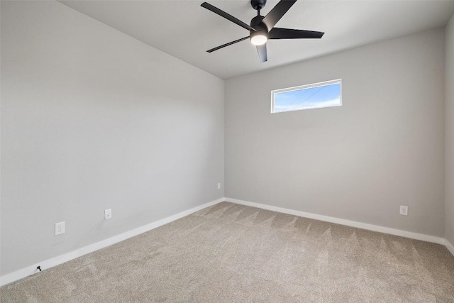 spare room featuring carpet, baseboards, and ceiling fan