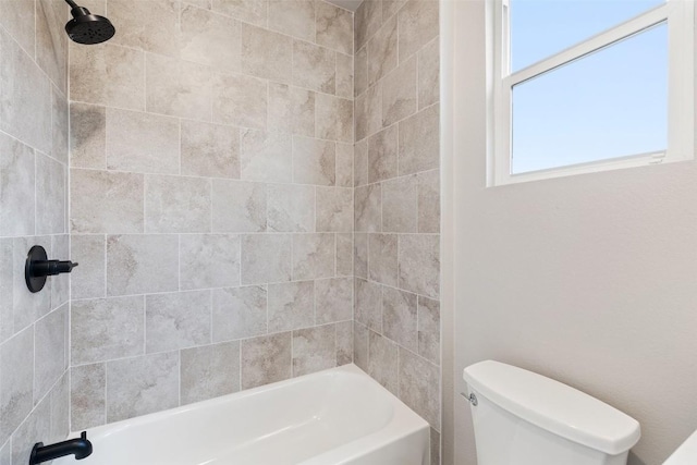 bathroom with tub / shower combination and toilet