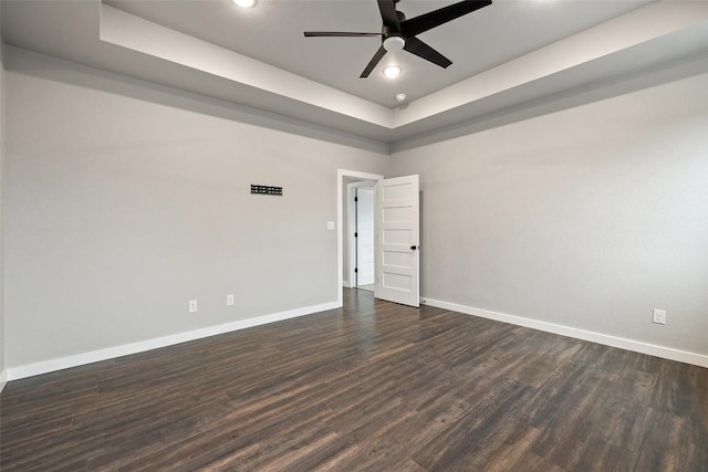 18200 Fair Ln, Jonestown, TX 78645 - unfurnished room featuring a raised ceiling, baseboards, dark wood-style flooring, ceiling fan, and recessed lighting