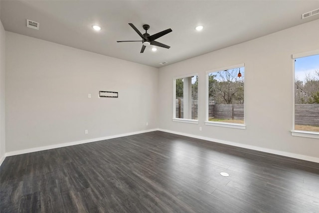 unfurnished room with dark wood-style flooring, recessed lighting, visible vents, and baseboards