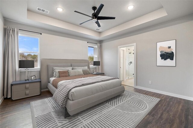 18200 Fair Ln, Jonestown, TX 78645 - bedroom featuring a raised ceiling, wood finished floors, baseboards, connected bathroom, and recessed lighting