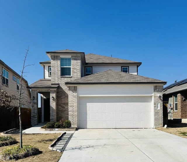 view of front of home with a garage, brick siding, and driveway