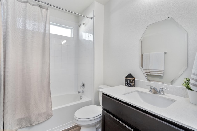 full bath featuring toilet, shower / bath combo with shower curtain, and vanity