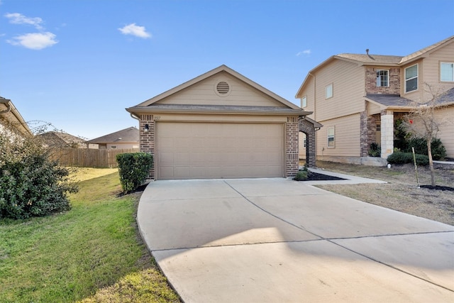 view of front of house with driveway, fence, a front lawn, and brick siding